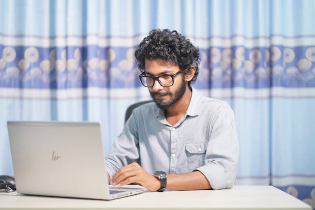 person sitting and working from a laptop